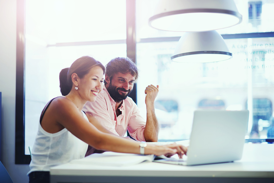 Two business people discussing ideas in co-working space with a